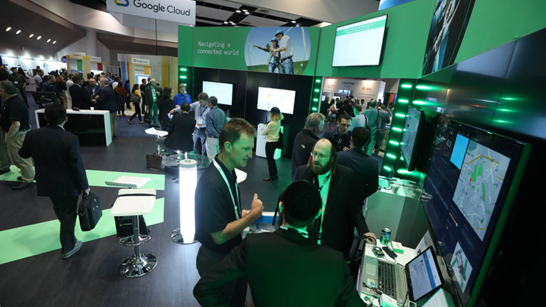 trade show floor with people at vendor booths