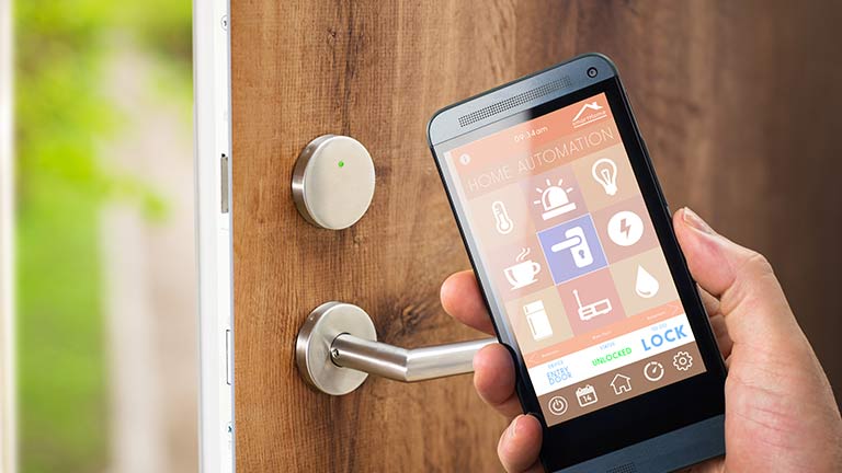 Person holding smartphone next to door