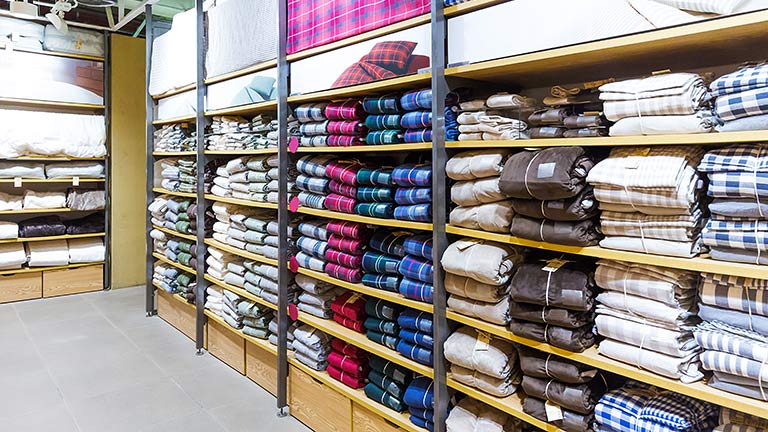Clothing stacked on shelving in a store