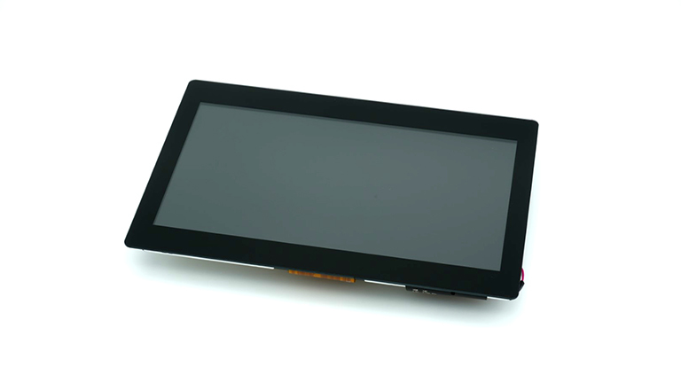 A close-up shot of a rectangular black display with a dark gray screen, showing a thin black bezel and a visible orange ribbon cable on the bottom right, against a plain white background.