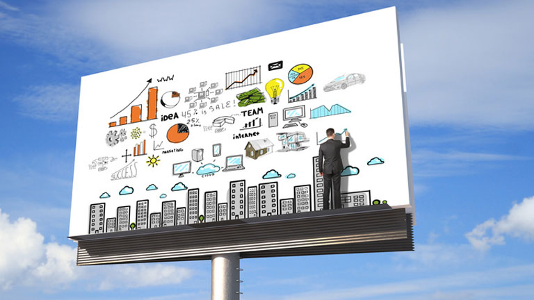 A billboard with the graphic of a cloud connected city on it