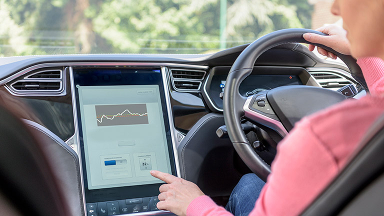 woman navigating a smart car dash pad