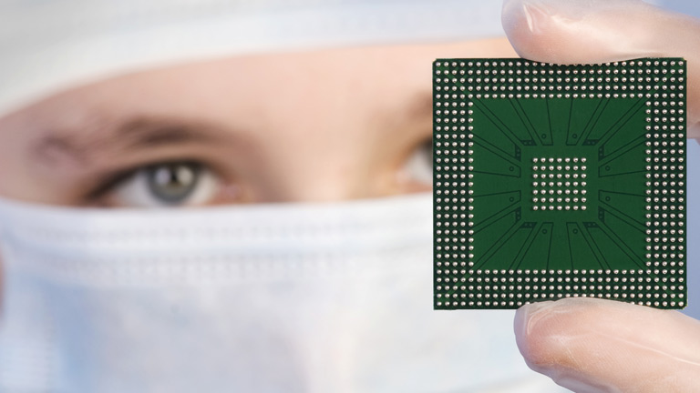 microprocessor chip being examined by worker