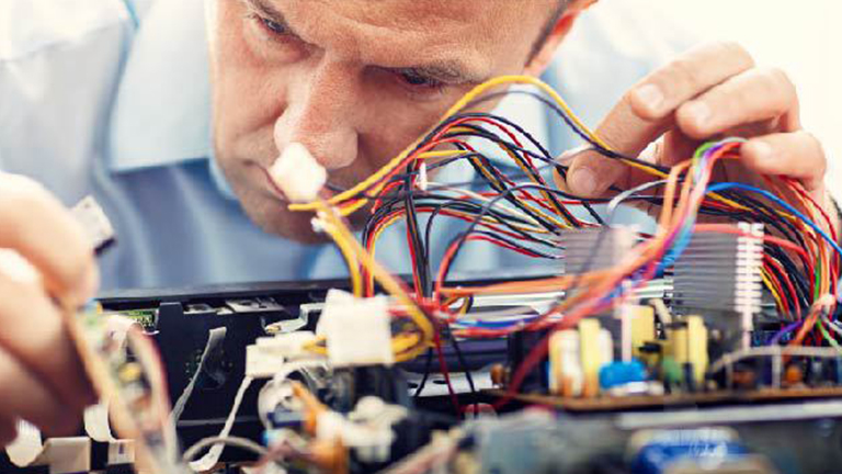 An engineer looks closely at an embedded system