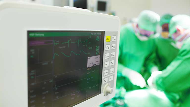 Cropped view of a heart monitor giving vital sign readings during an operation