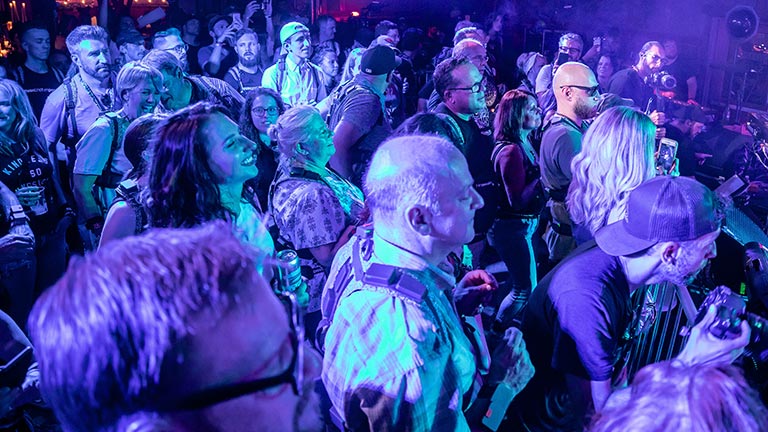 Crowd watching live rock band playing on stage