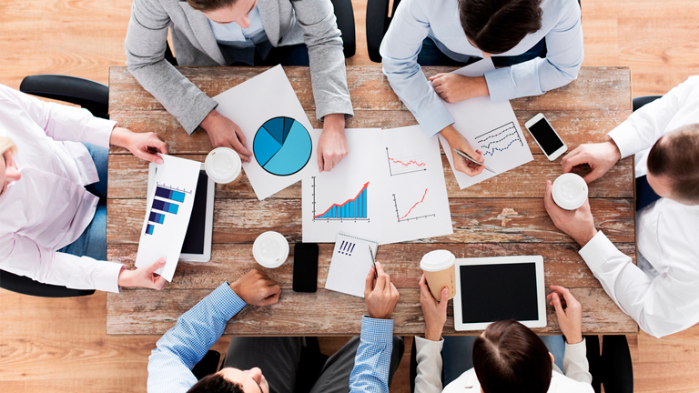 Business people around a table in a meeting about IoT security