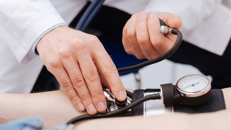 doctor taking blood pressure reading